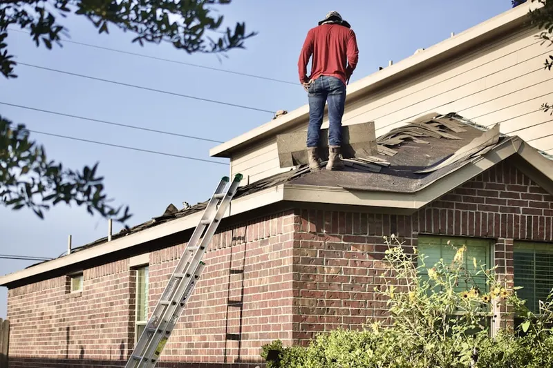 Professional roofer working on a residential roof in Crescent Pointe